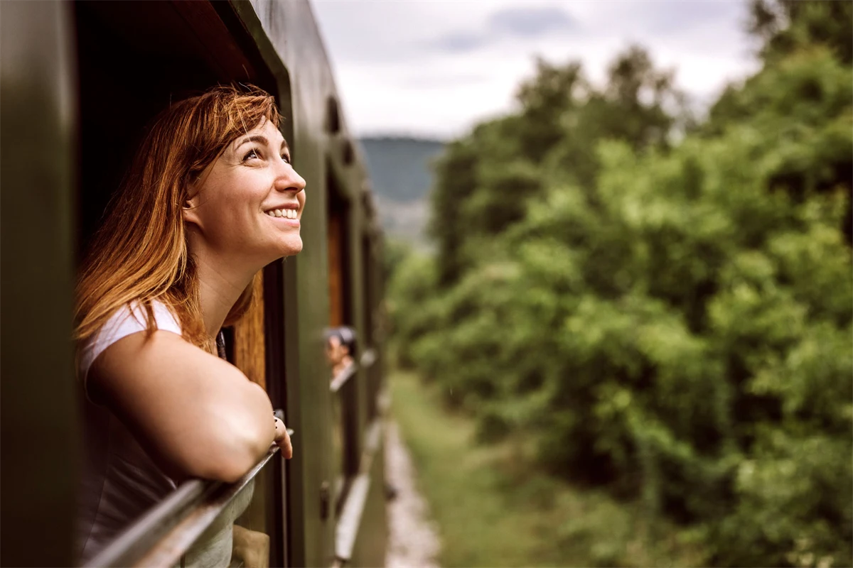 Ung kvinna på semester tar tåget ut i världen.