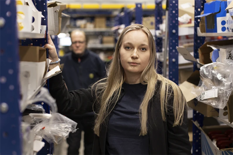 Två lagerarbetare med bestämt och stolt uttryck.